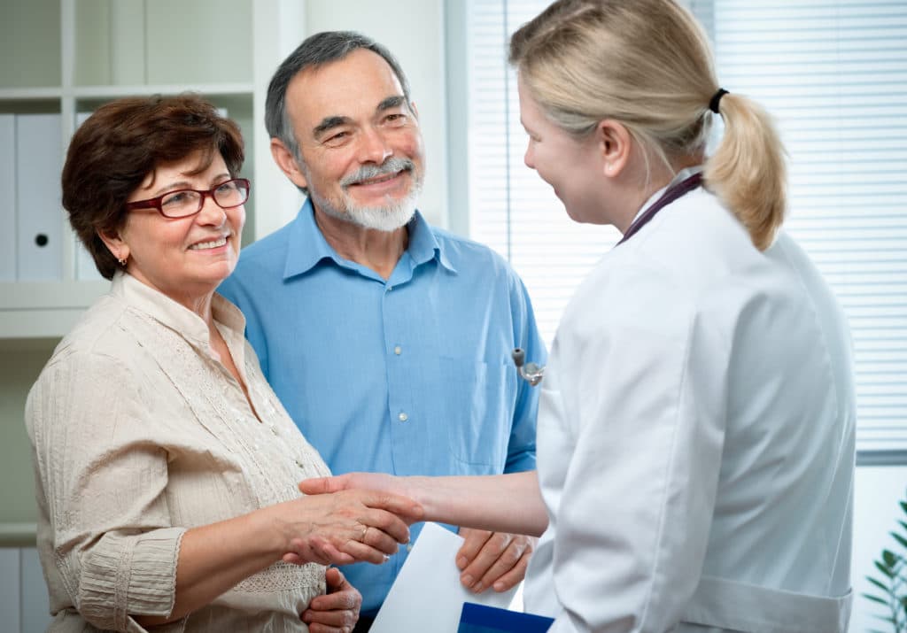 A clinician meeting with a patient and family member